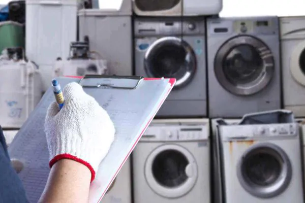 contractors checking the old washer and dyers