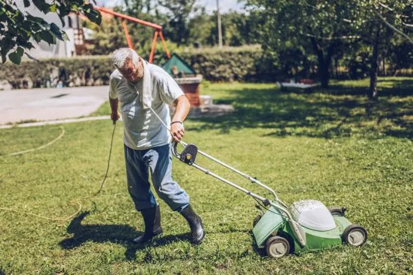 man using lawn mower 