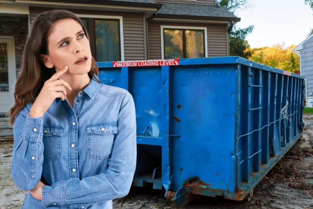 young woman standing in front of 20 yard dumpster